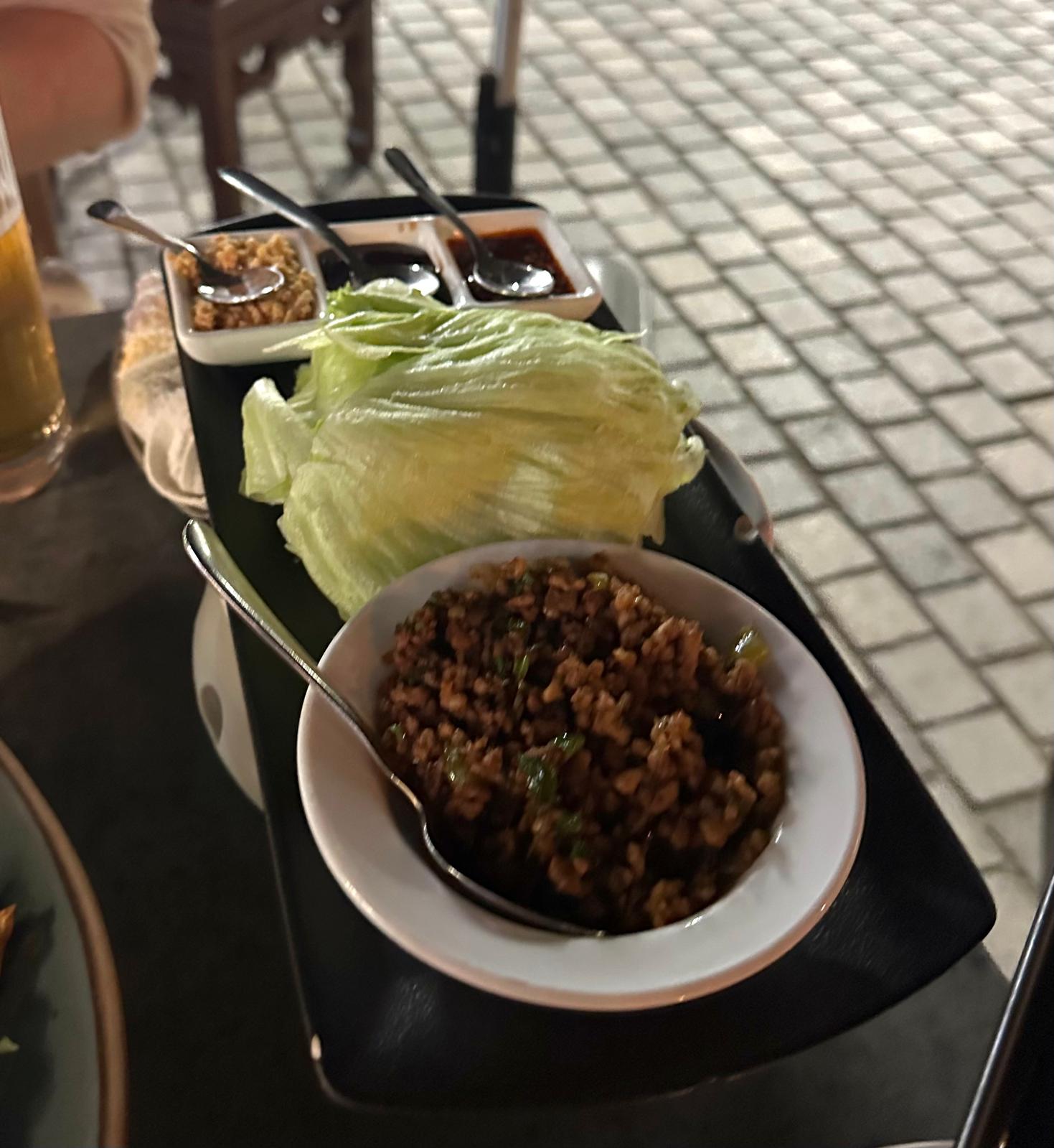 Spicy pork with lettuce leaves